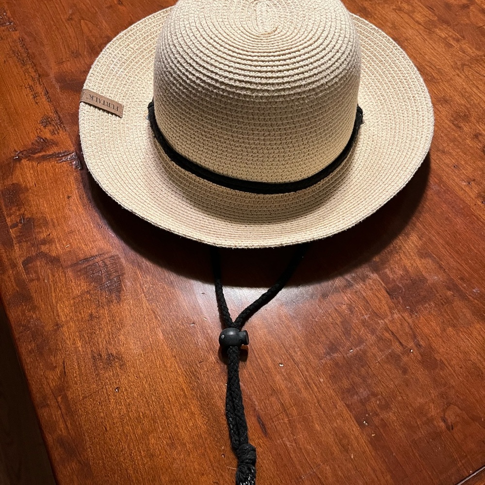 New, never worn, straw hat with black string, women’s size medium.